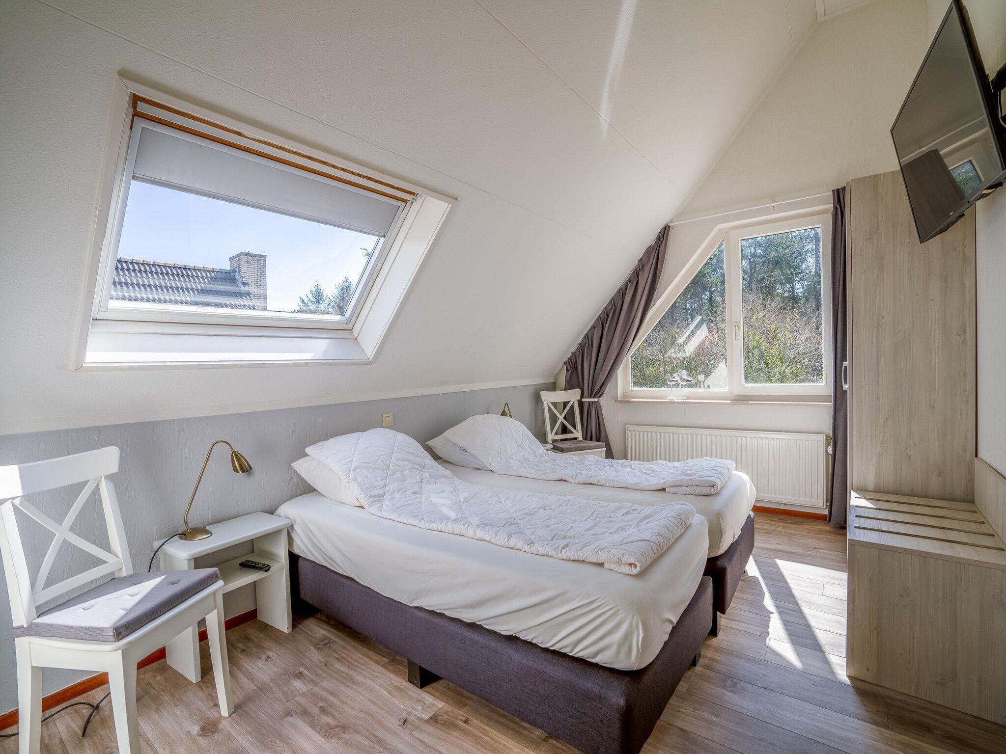 Een slaapkamer van Kamperfoelie 91 in De Koog