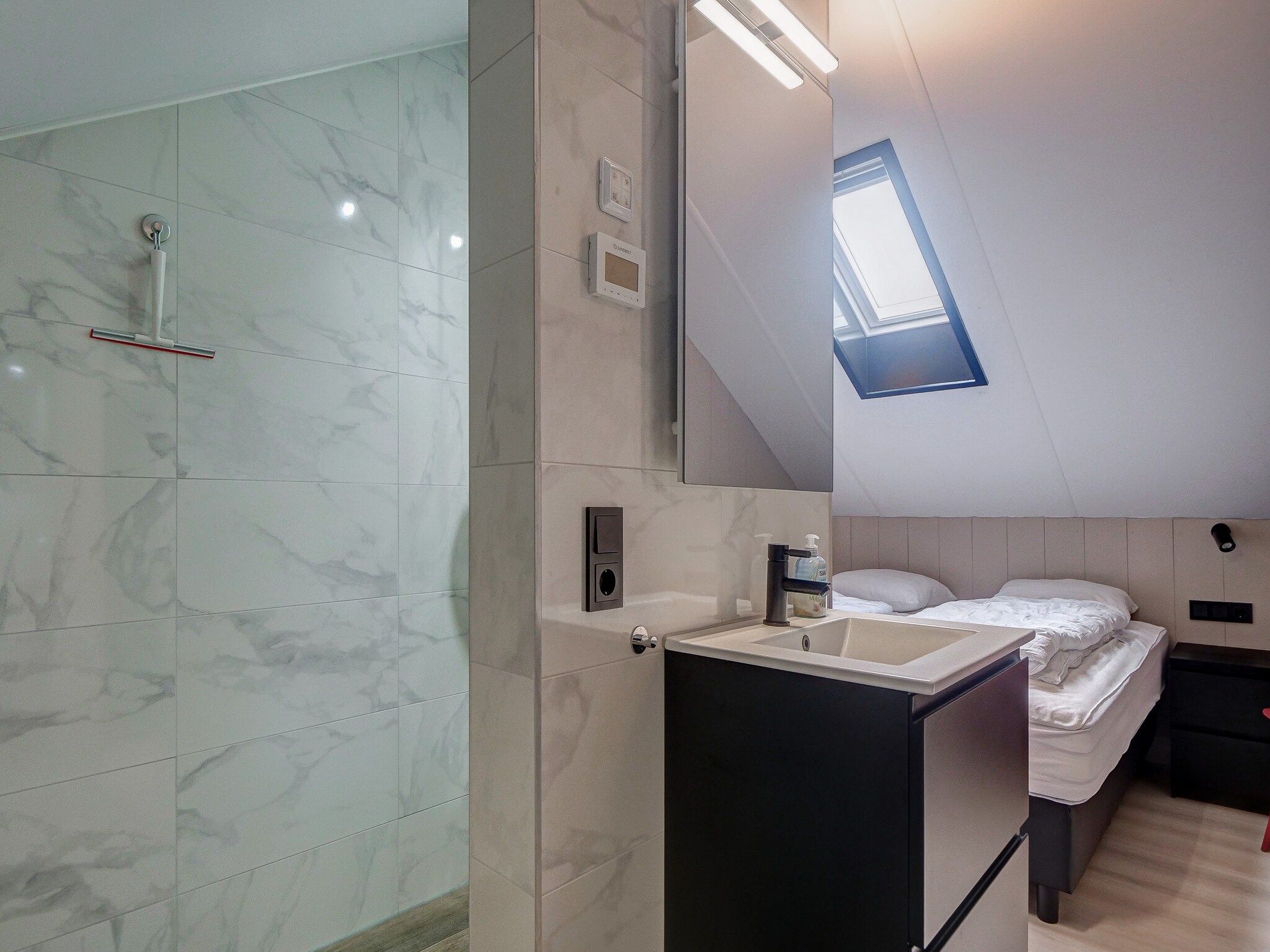 Een slaapkamer van Huis Zand in Julianadorp aan zee
