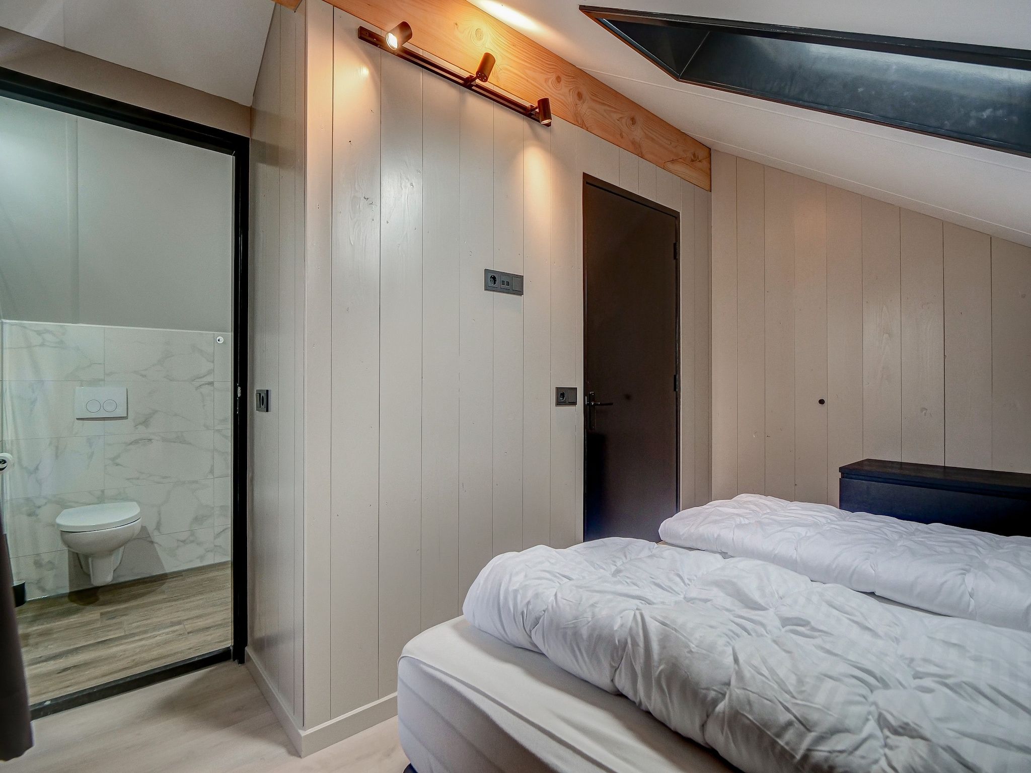 Een slaapkamer van Huis Zand in Julianadorp aan zee
