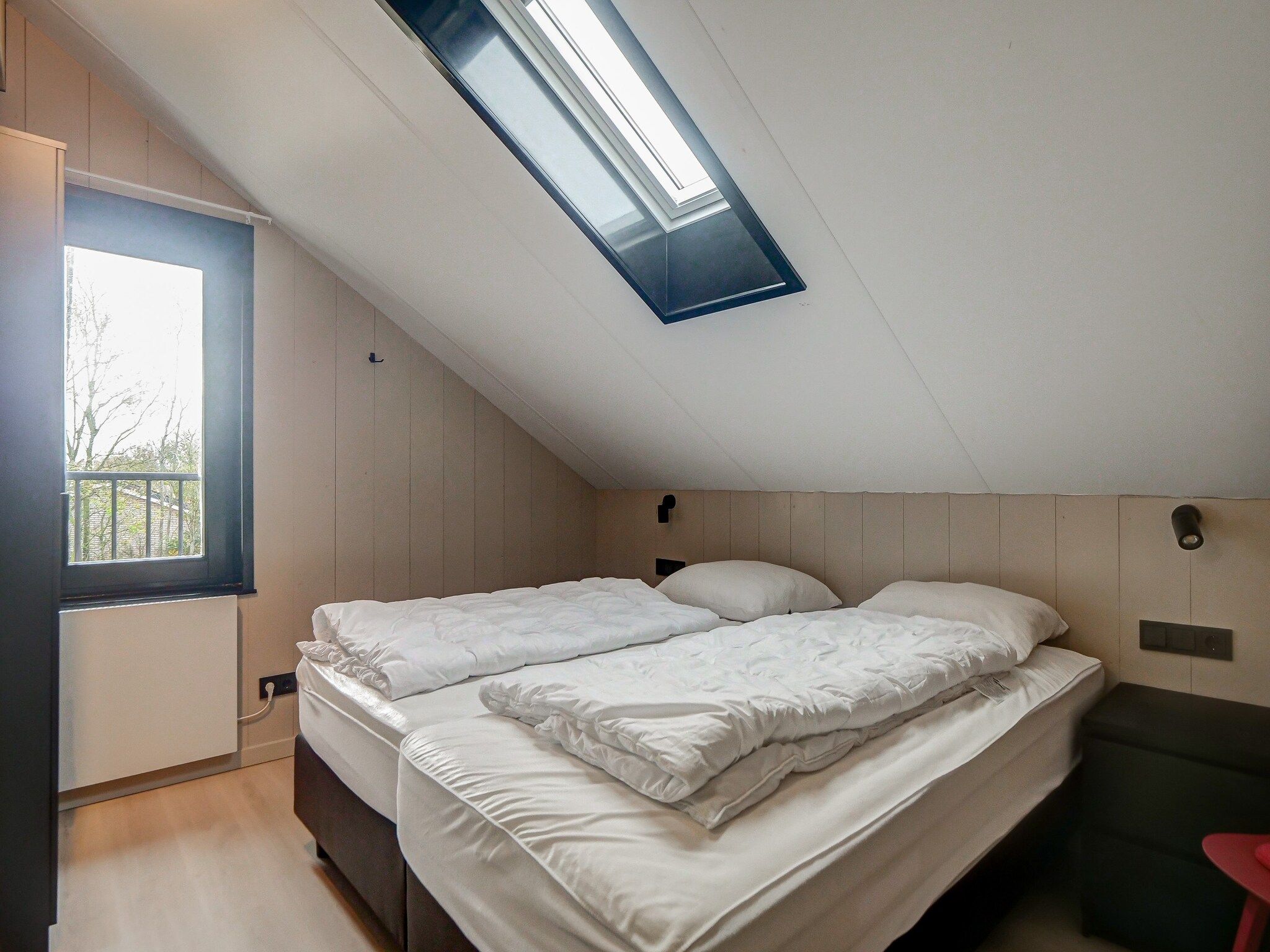 Een slaapkamer van Huis Zand in Julianadorp aan zee