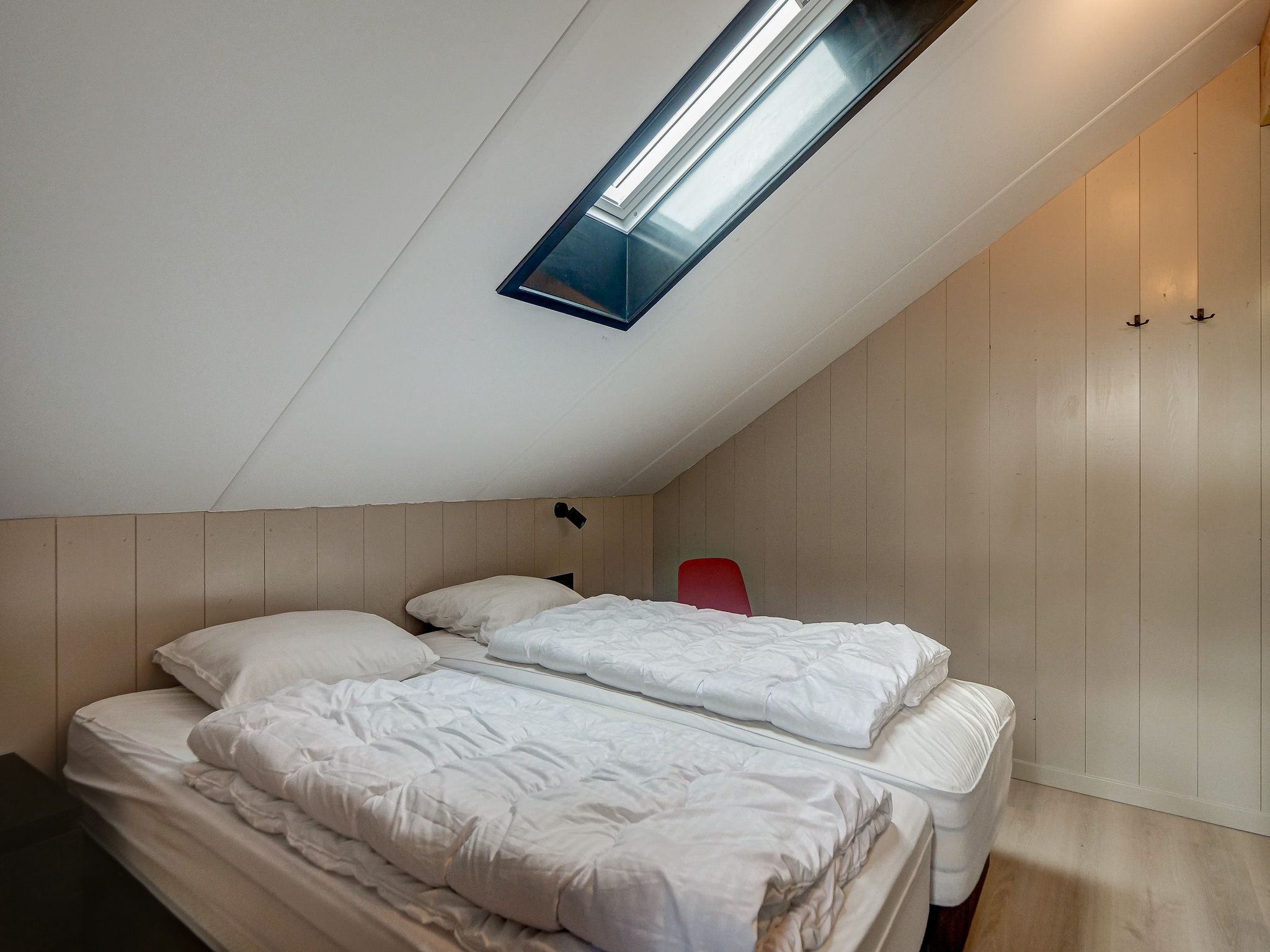 Een slaapkamer van Huis Zand in Julianadorp aan zee
