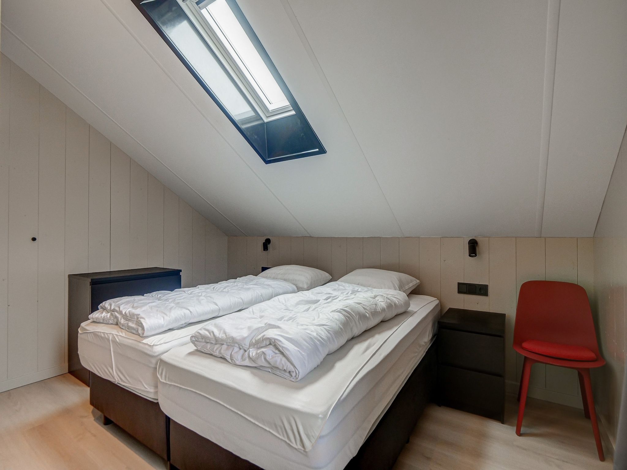 Een slaapkamer van Huis Zand in Julianadorp aan zee