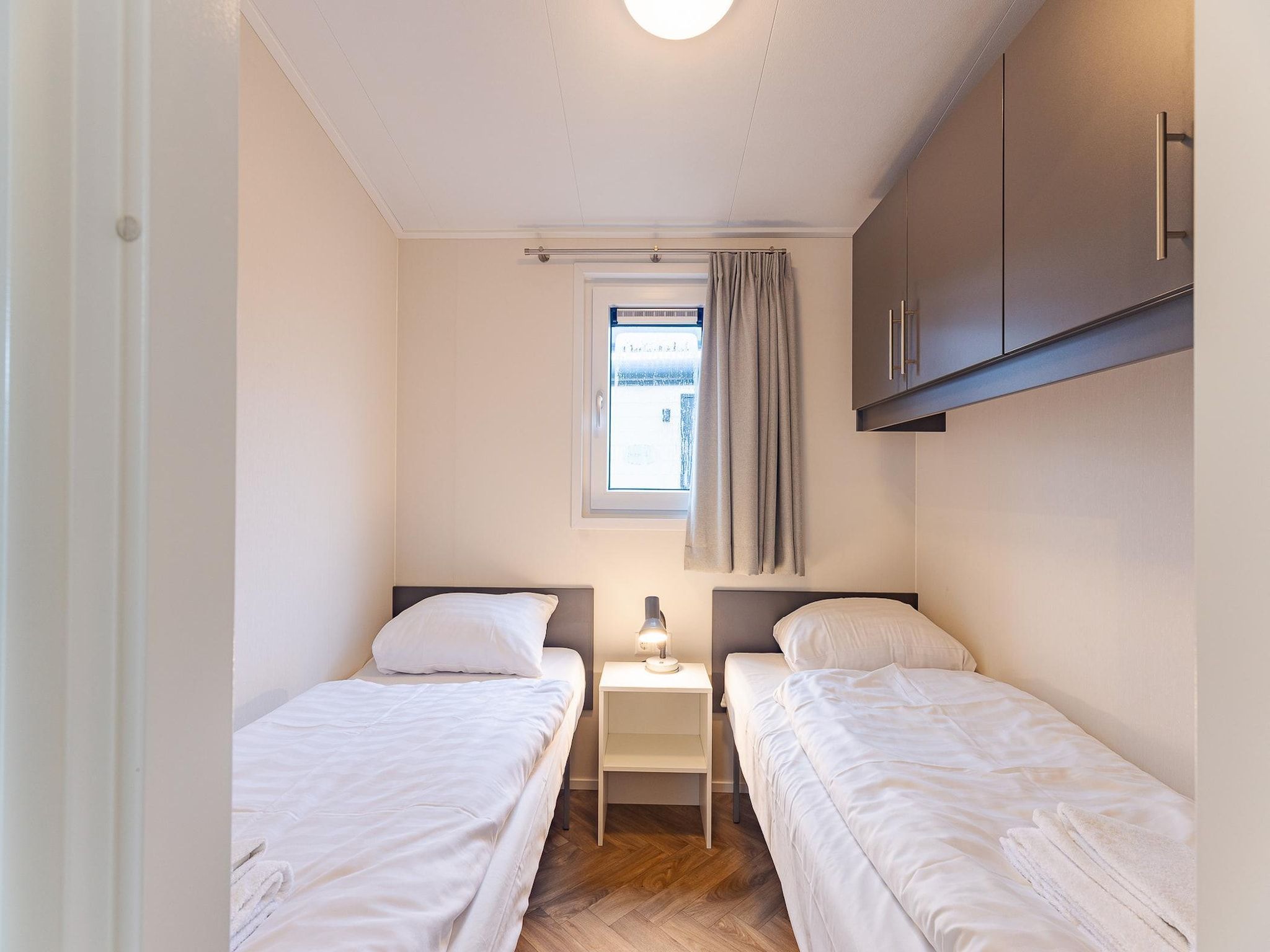 Een slaapkamer van Duinhoeve chalet Schelp in Burgh-Haamstede