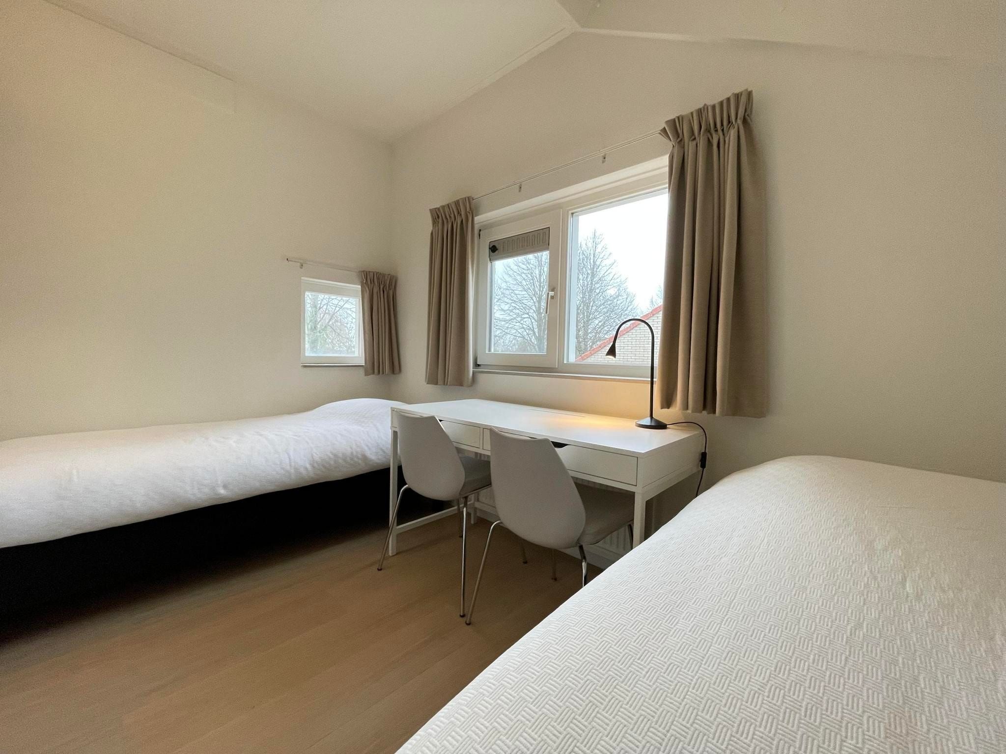 Een slaapkamer van Watervilla de Ijsvogel in Langweer