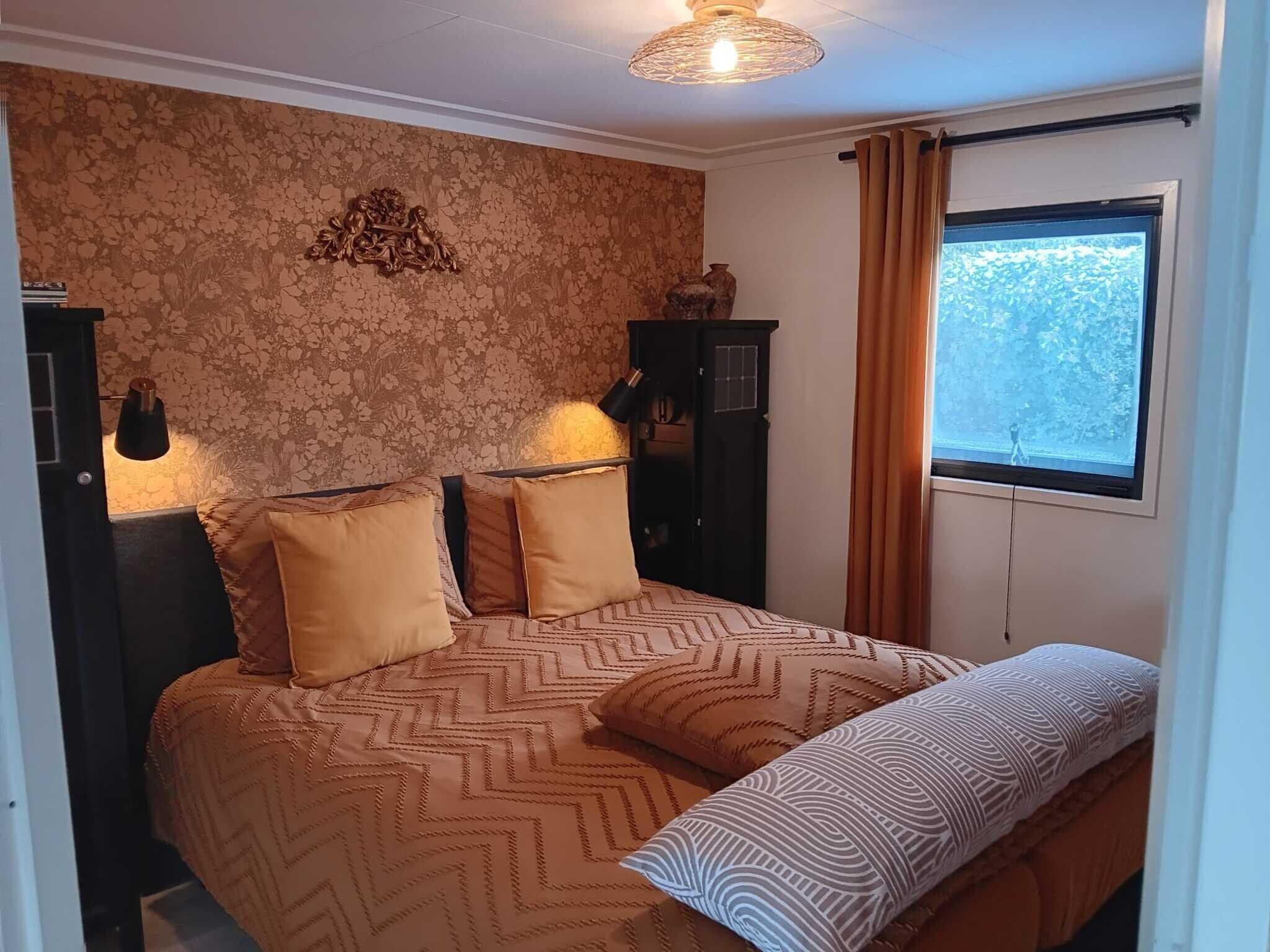 Een slaapkamer van Vechtdalchalet de Wilg in Rheezerveen
