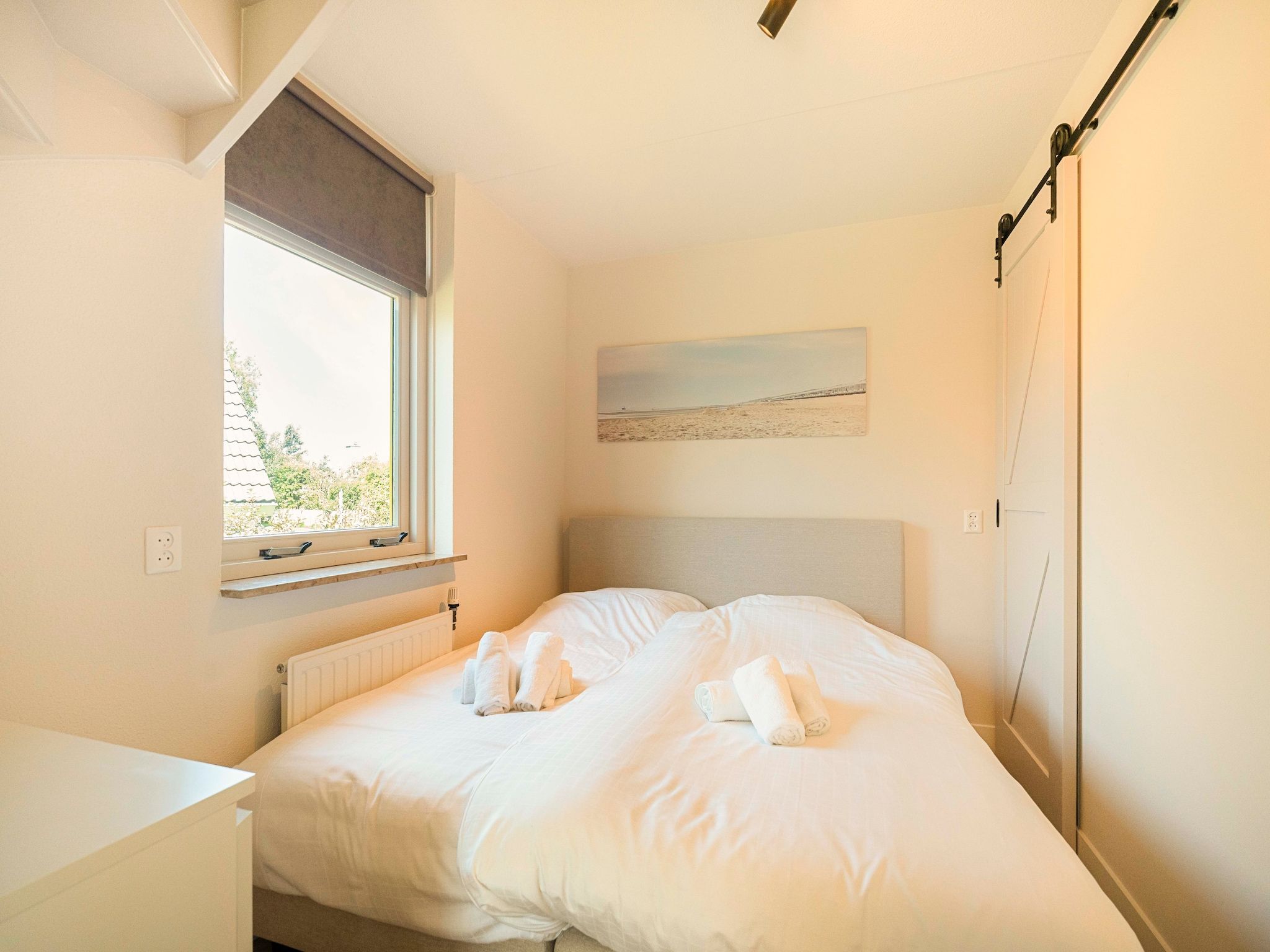 Een slaapkamer van Strandslag Bungalow 68 in Julianadorp