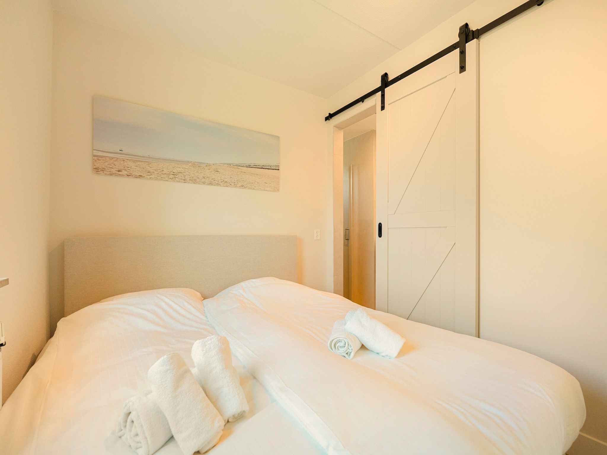 Een slaapkamer van Strandslag Bungalow 68 in Julianadorp