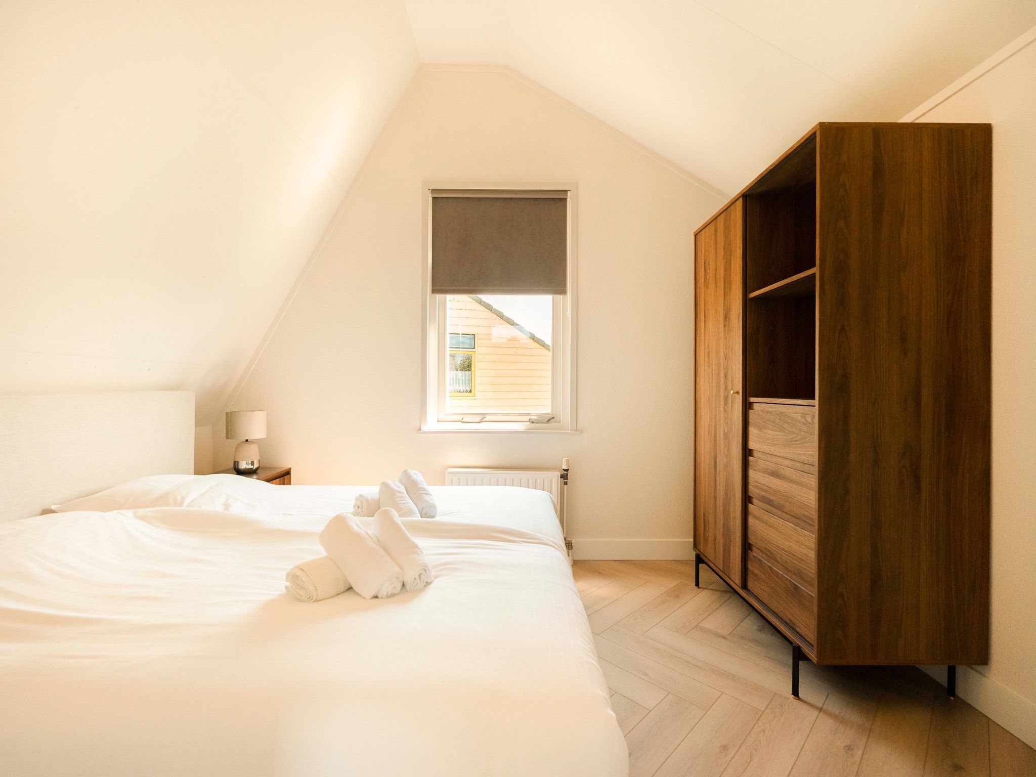 Een slaapkamer van Strandslag Bungalow 68 in Julianadorp
