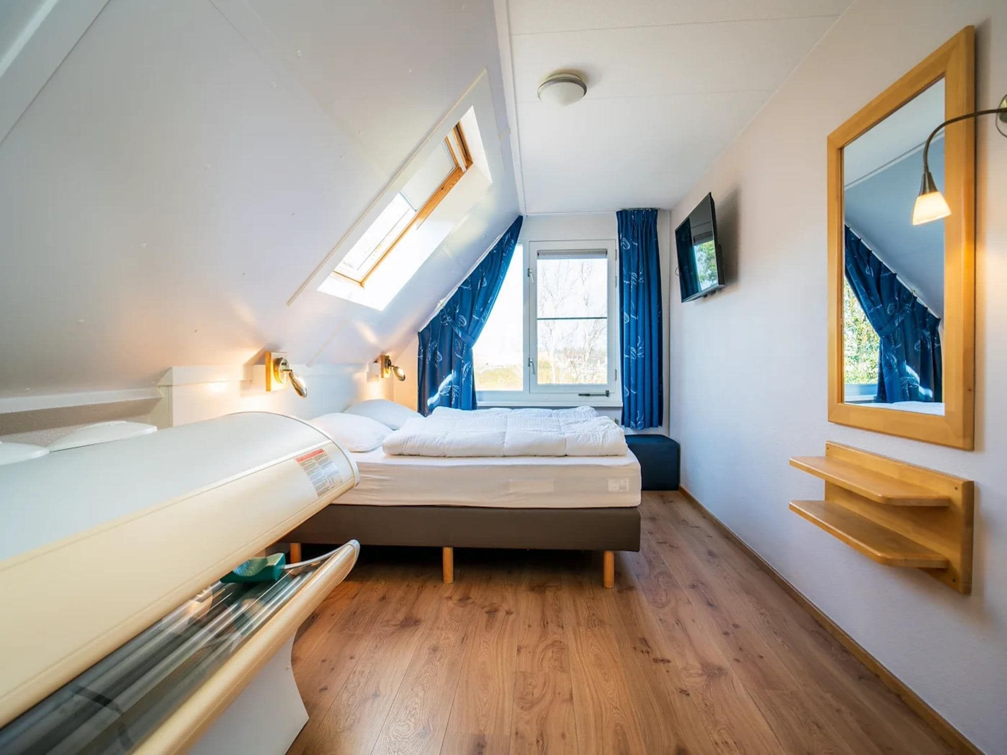 Een slaapkamer van Luxury 4-person villa in a nature reserve on Texel in De Koog