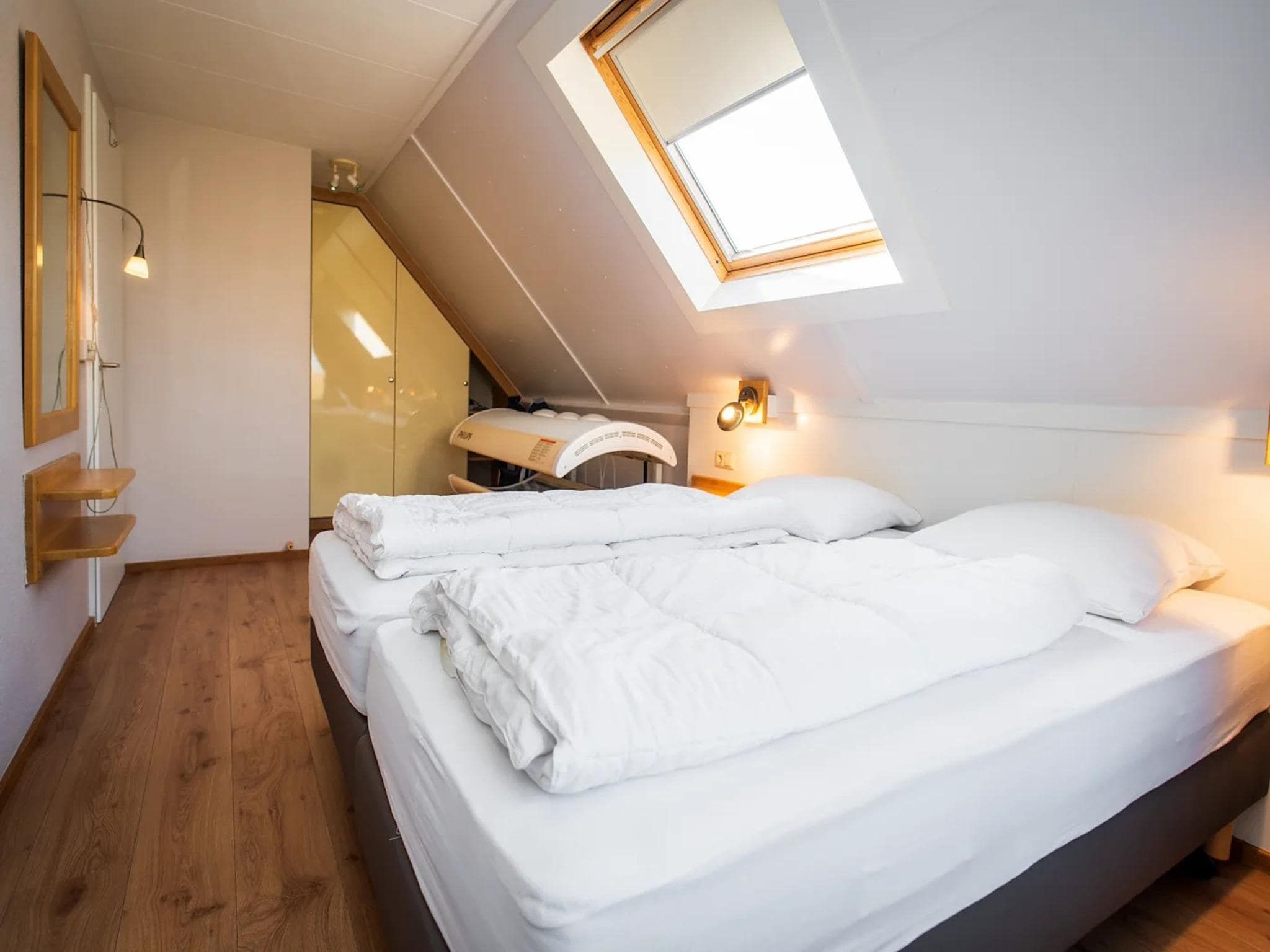 Een slaapkamer van Luxury 4-person villa in a nature reserve on Texel in De Koog