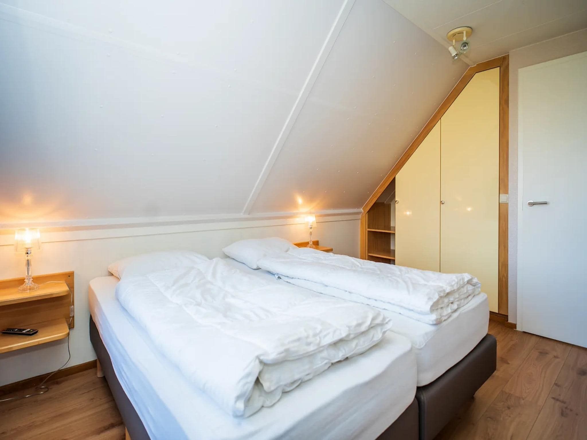 Een slaapkamer van Luxury 4-person villa in a nature reserve on Texel in De Koog