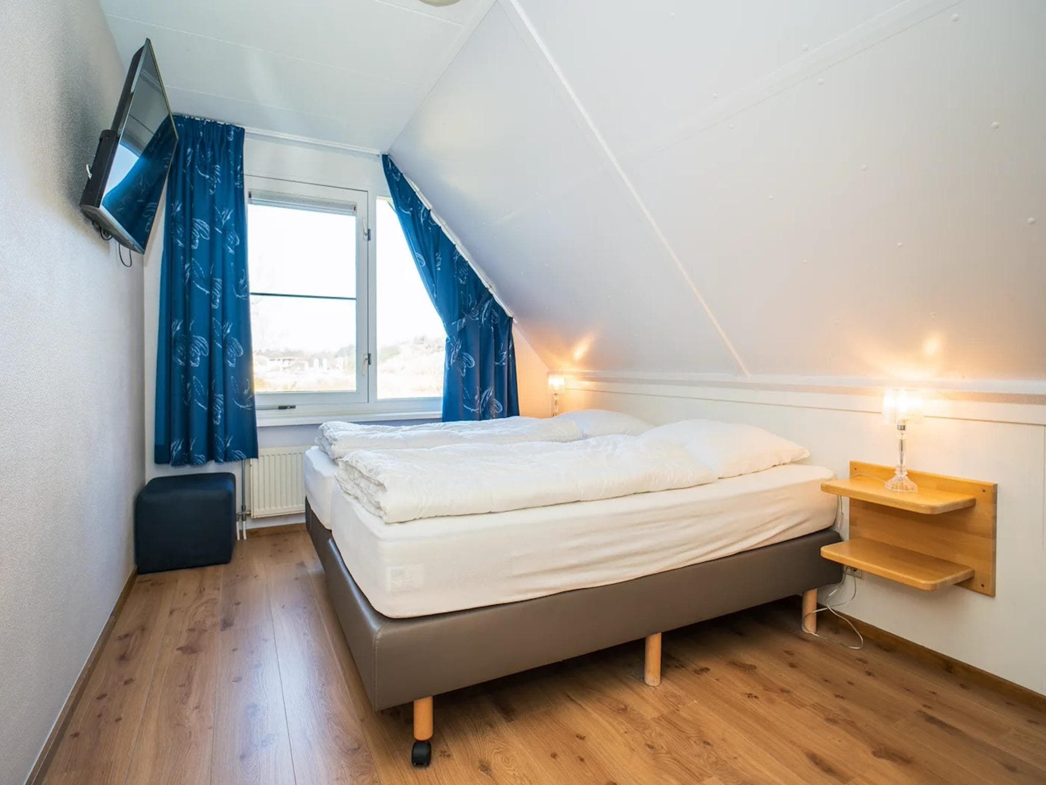 Een slaapkamer van Luxury 4-person villa in a nature reserve on Texel in De Koog
