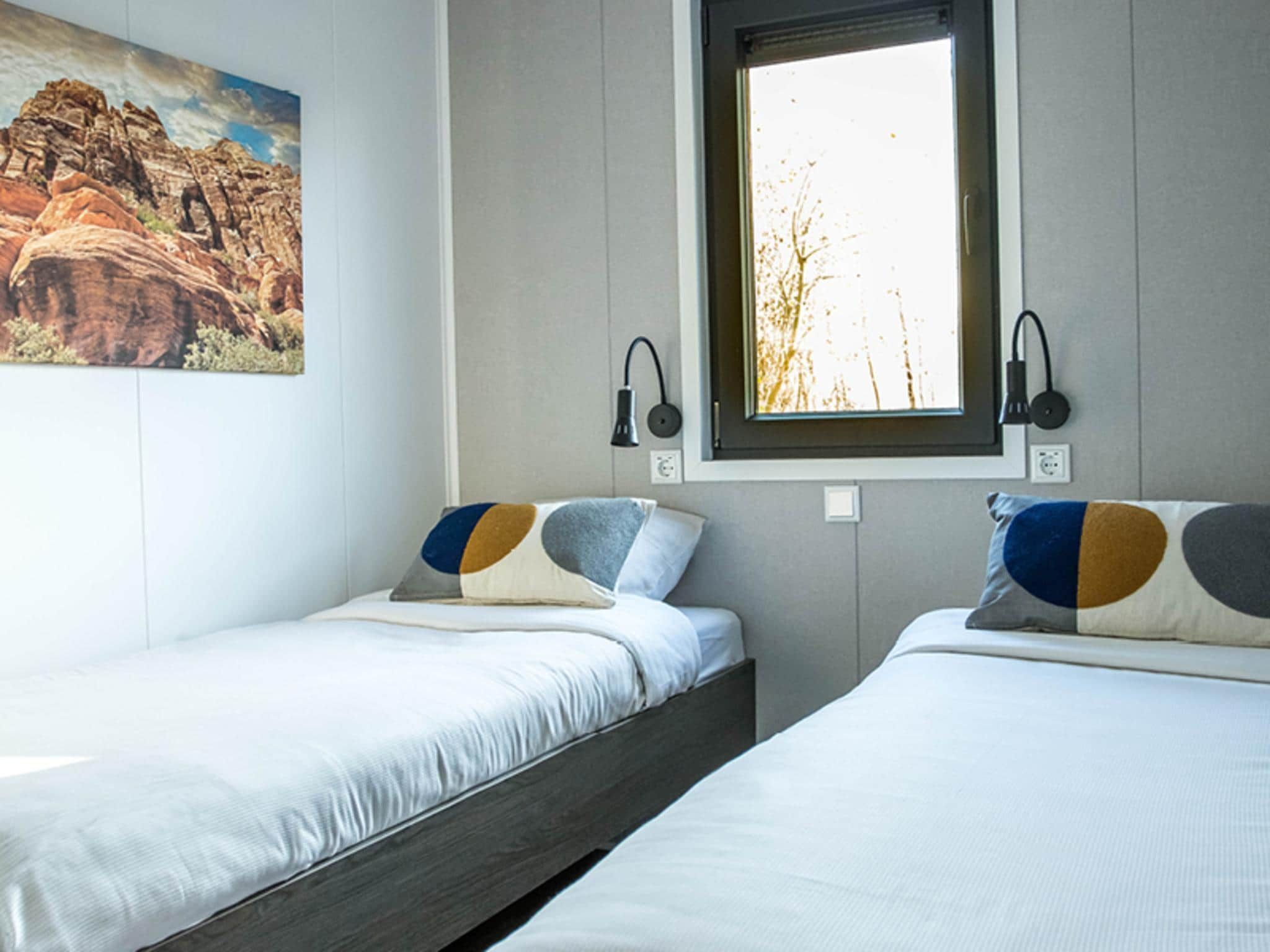 Een slaapkamer van Red Rock Cottage in Slagharen