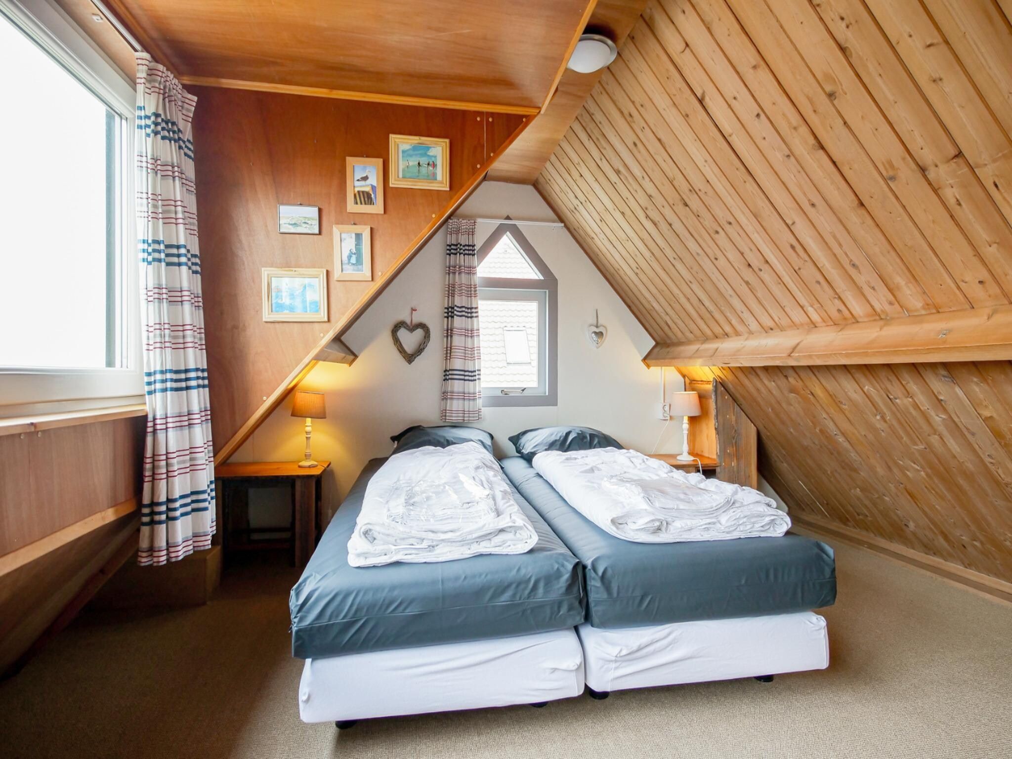 Een slaapkamer van Vakantiehuisje Vloed in Callantsoog