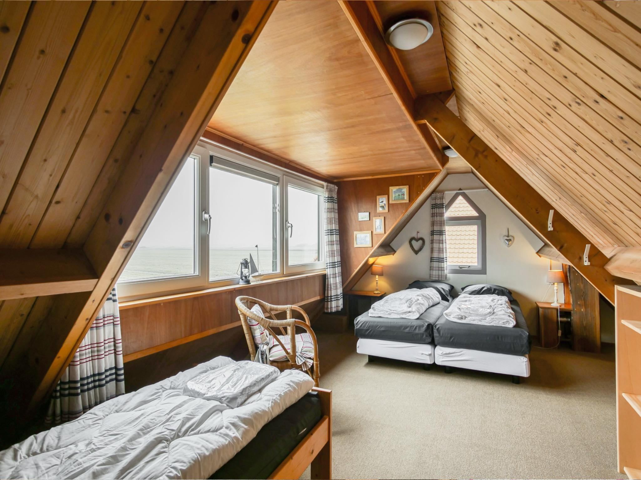 Een slaapkamer van Vakantiehuisje Vloed in Callantsoog