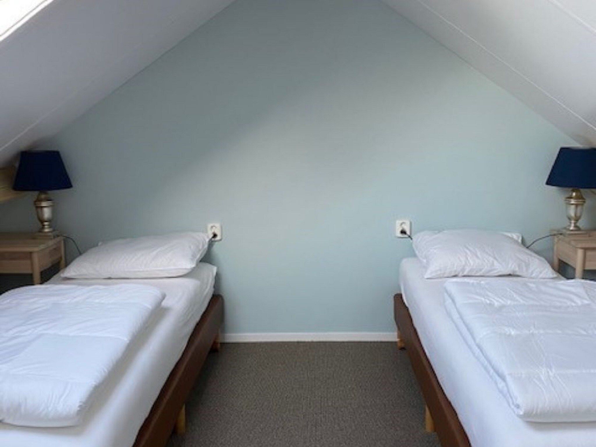 Een slaapkamer van Landgoed Eysinga State 2 in Sint Nicolaasga