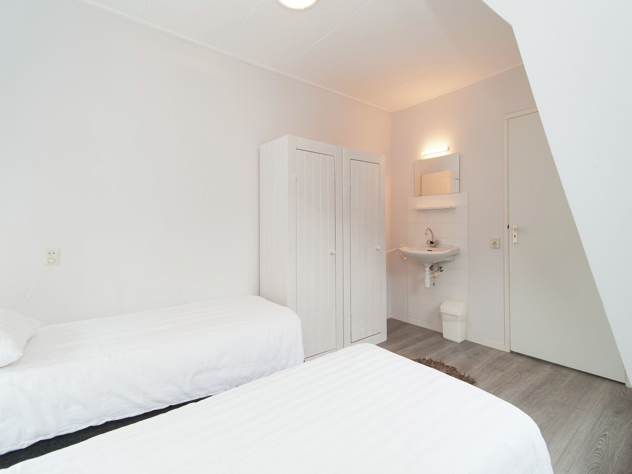Een slaapkamer van Huize Glory Parel in Bergen aan zee