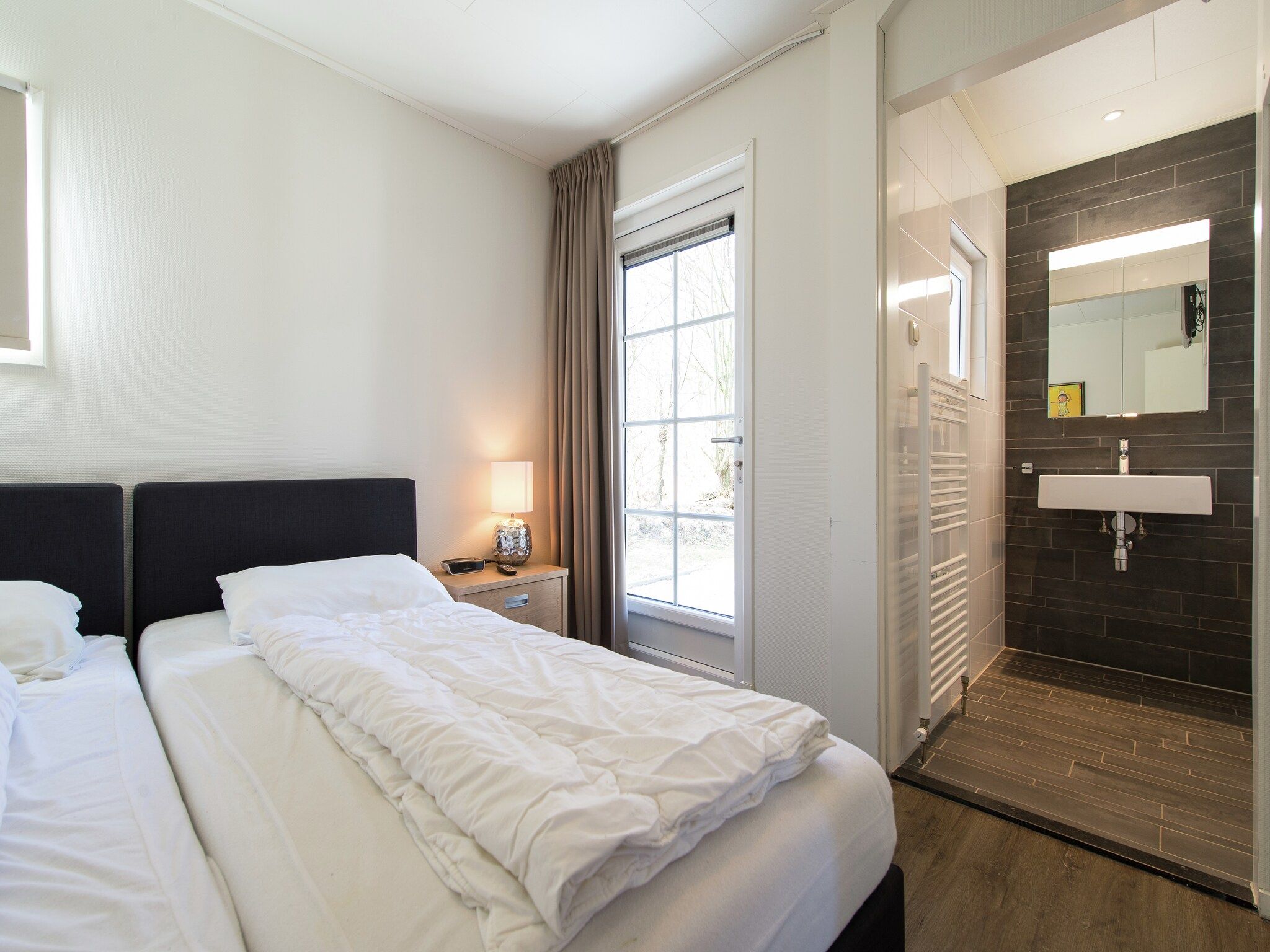 Een slaapkamer van Vakantiepark Boomhiemke 3 in Hollum