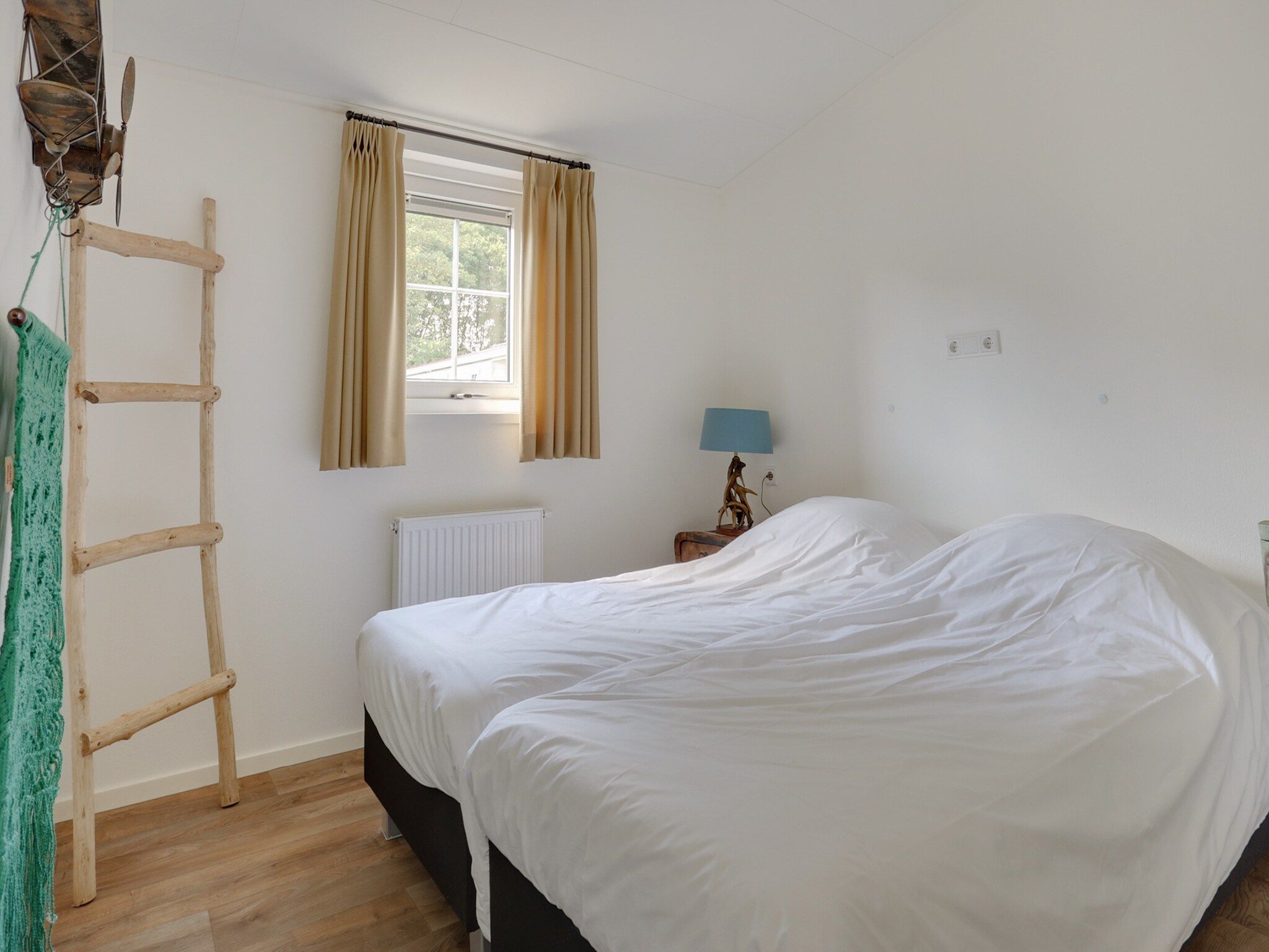 Een slaapkamer van Vakantiepark Sandberghe 6 in Uden