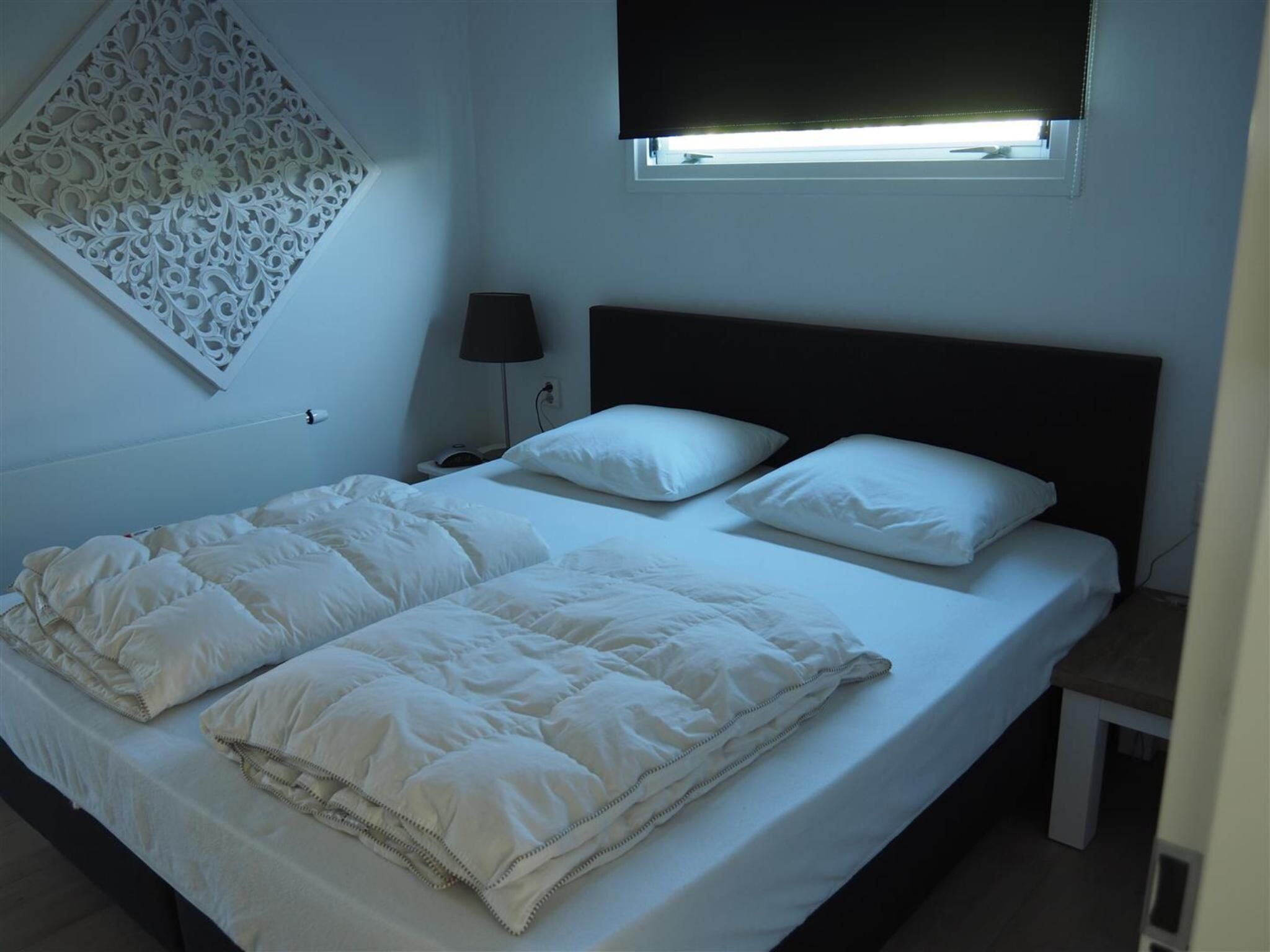 Een slaapkamer van Dichtbij de Oosterschelde in Kattendijke