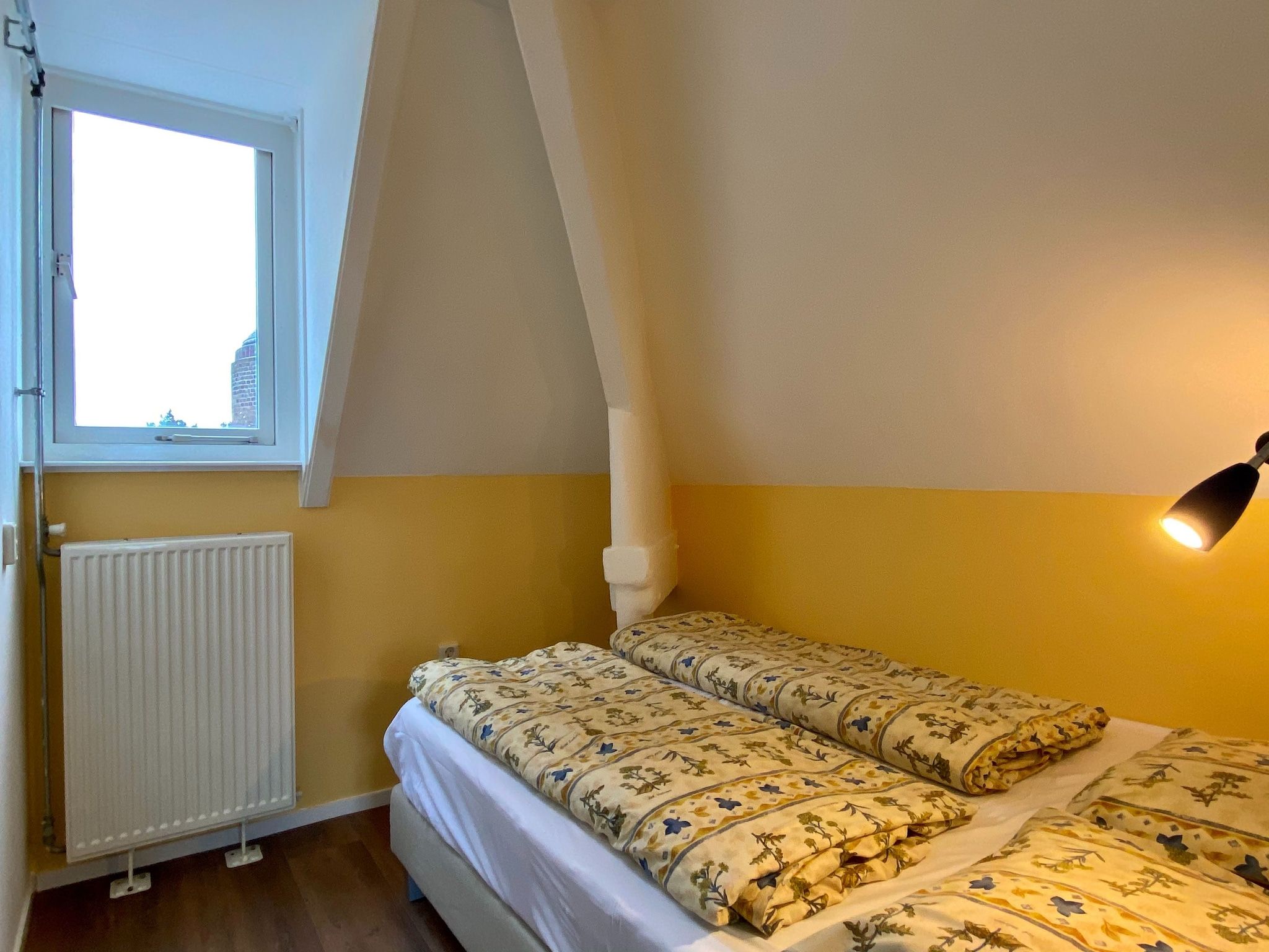Een slaapkamer van Huize Glory Smaragd in Bergen aan Zee