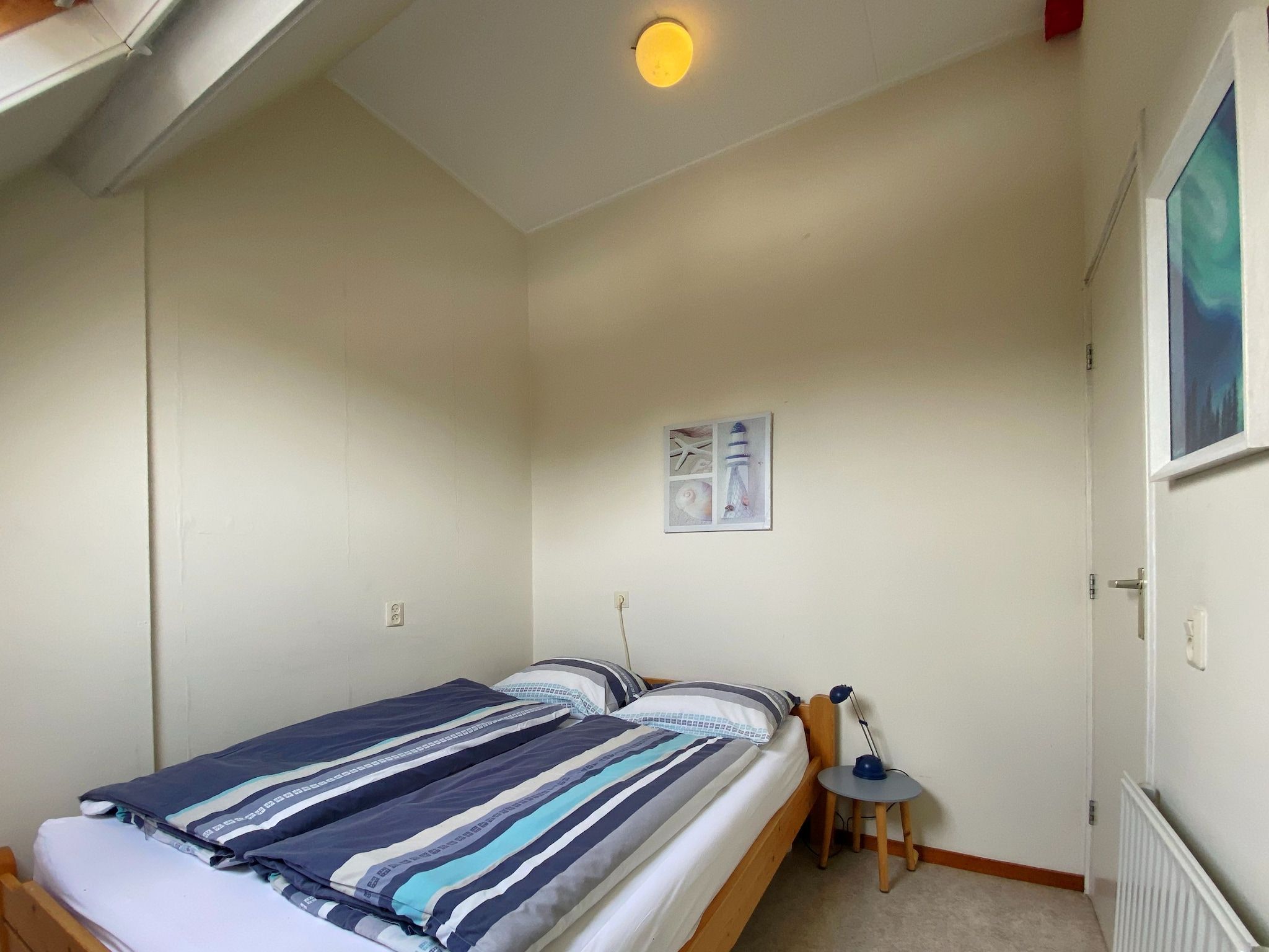 Een slaapkamer van Huize Glory Jade in Bergen aan zee