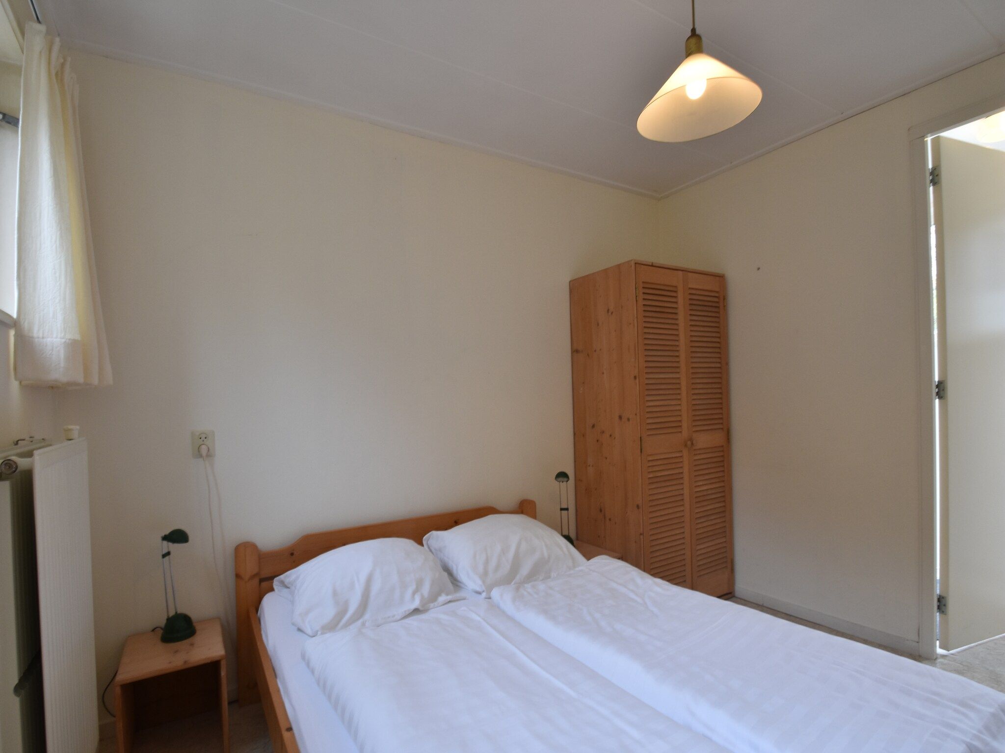 Een slaapkamer van Huize Glory Robijn in Bergen aan zee