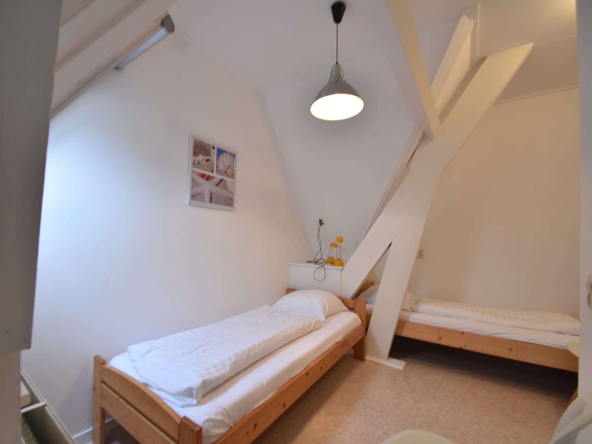 Een slaapkamer van Huize Glory Granaat in Bergen aan zee