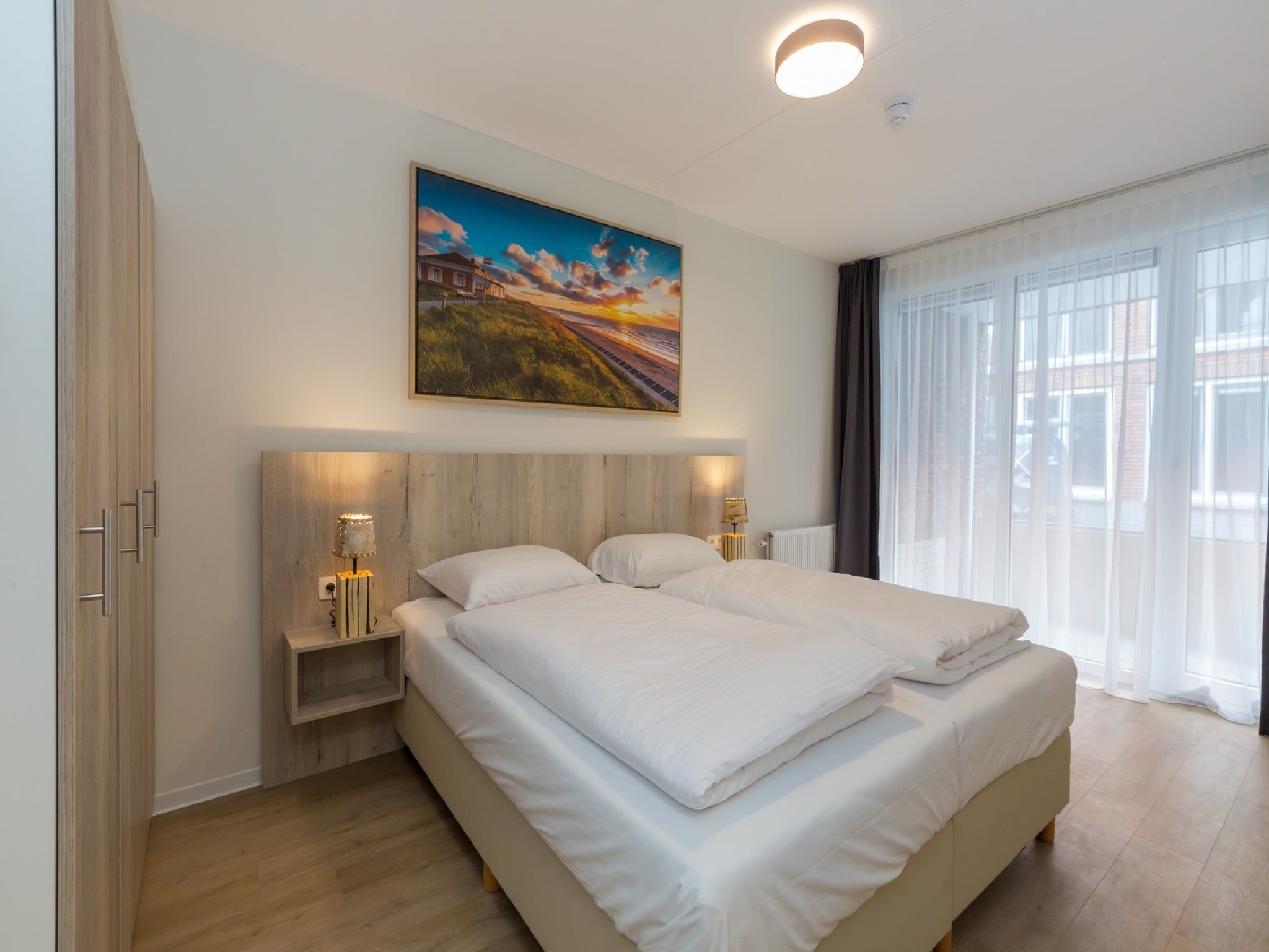 Een slaapkamer van Aparthotel Zoutelande - 4 pers luxe appartement in Zoutelande