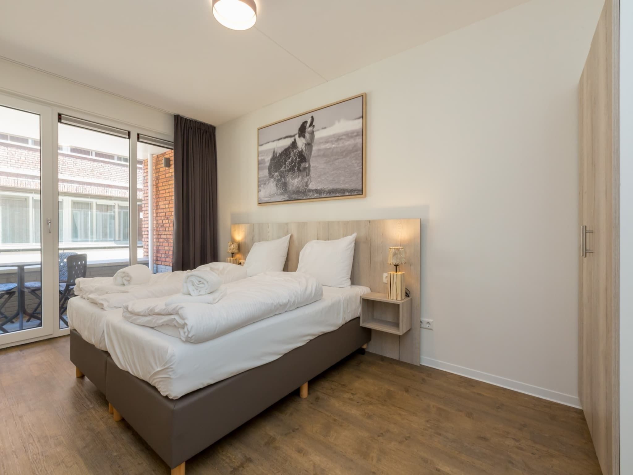 Een slaapkamer van Aparthotel Zoutelande - 4 pers luxe appartement - huisdier in Zoutelande