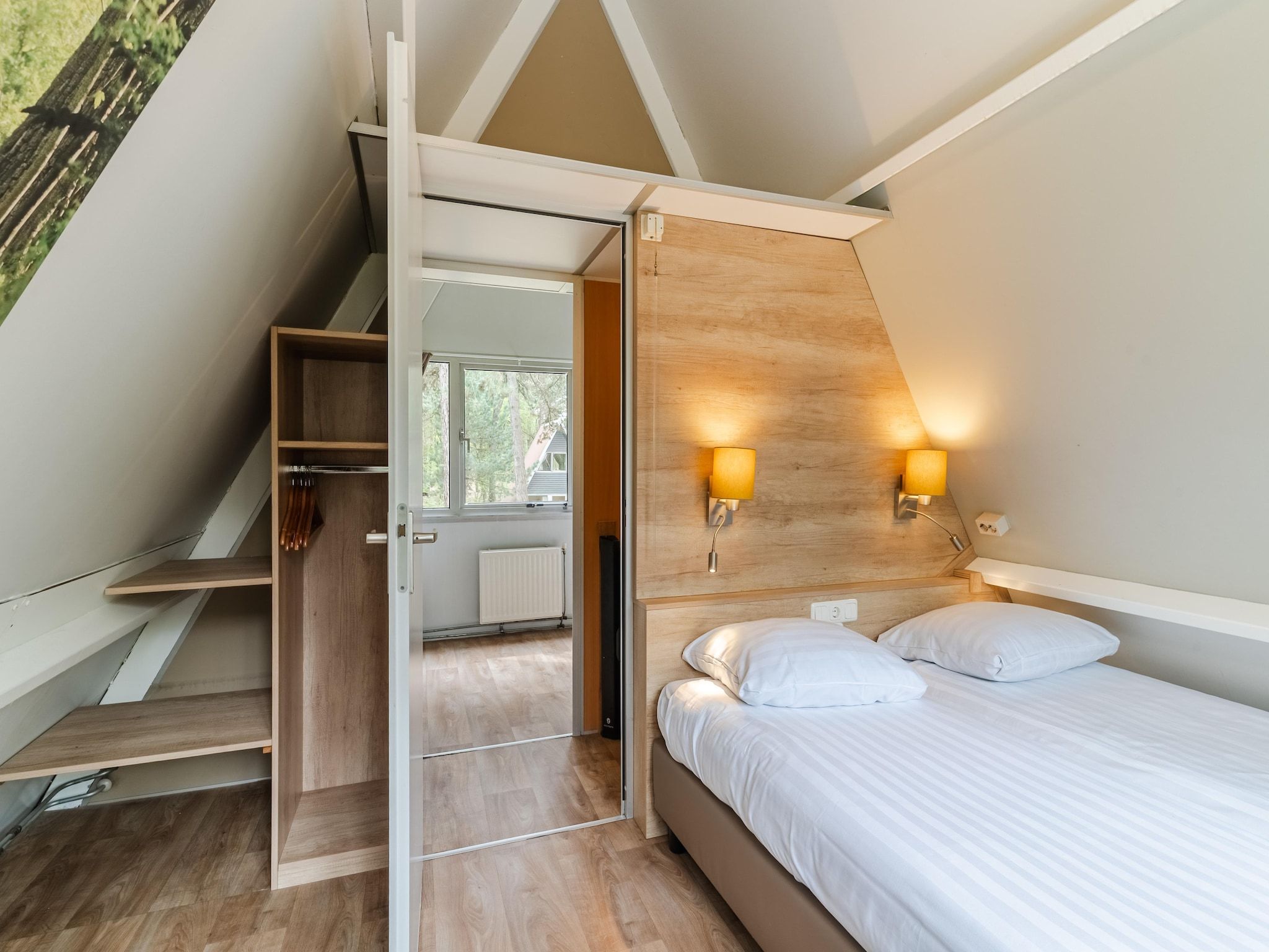 Een slaapkamer van Bospark 't Wolfsven 7 in Mierlo
