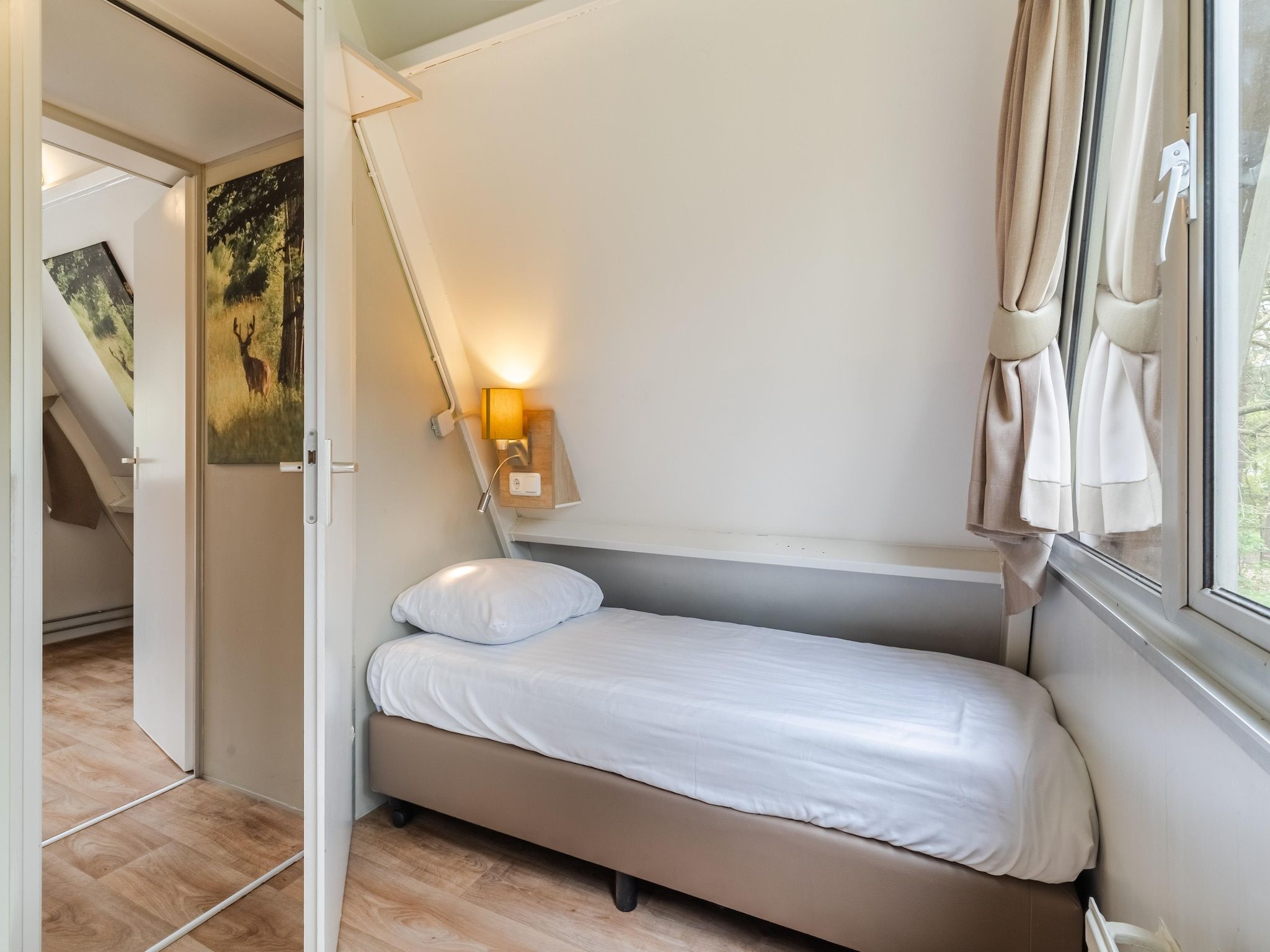 Een slaapkamer van Bospark 't Wolfsven 7 in Mierlo