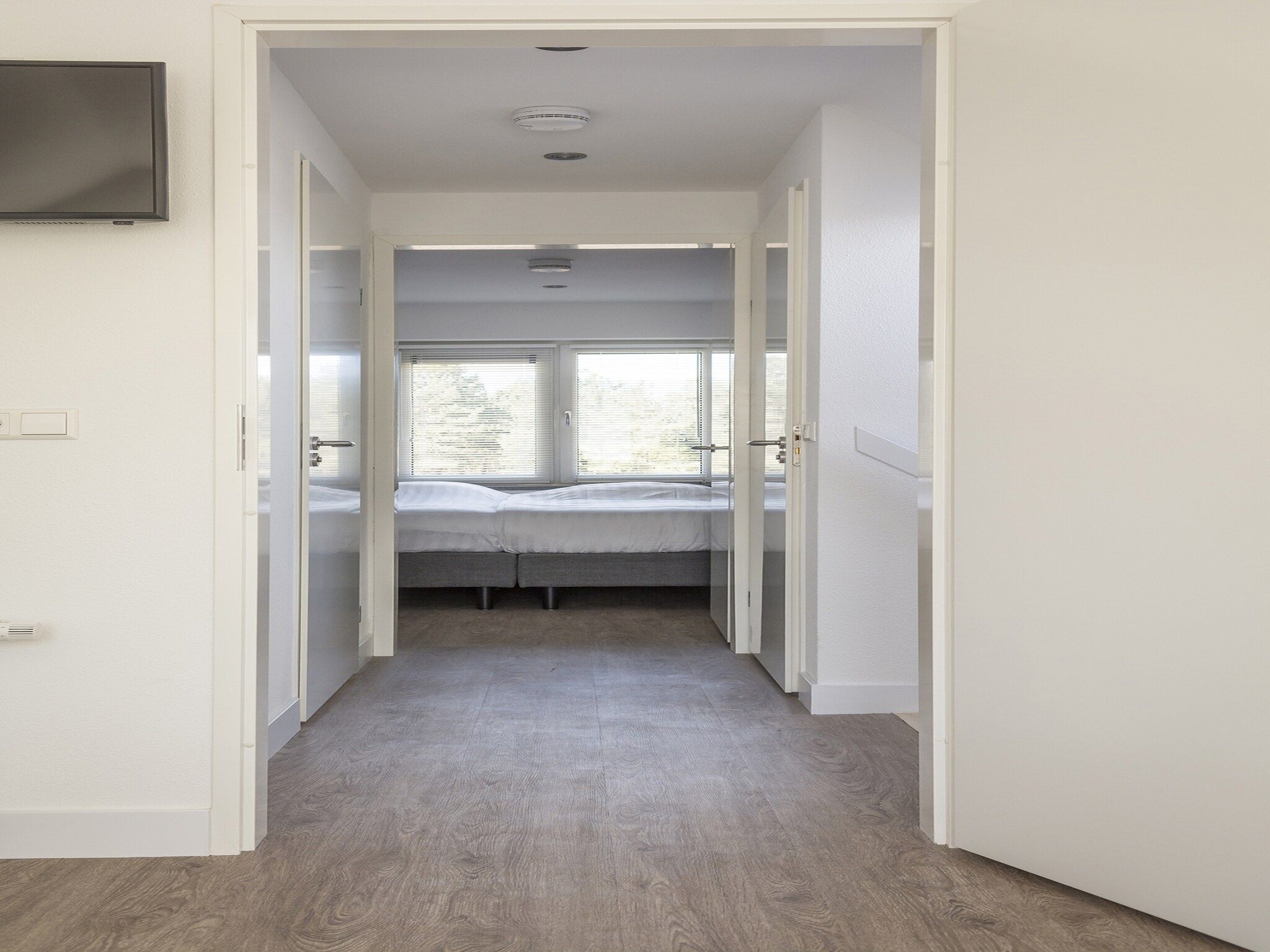 Een slaapkamer van Landhuis Bouwlust K in De Cocksdorp Texel