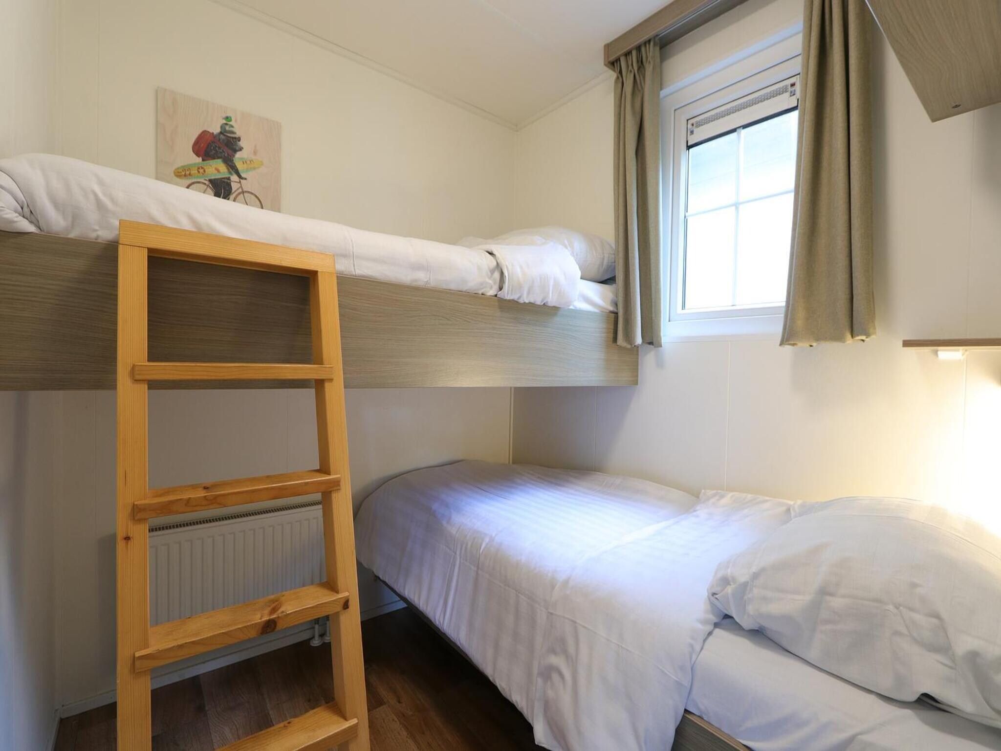 Een slaapkamer van Mobilehome 6 in Otterlo