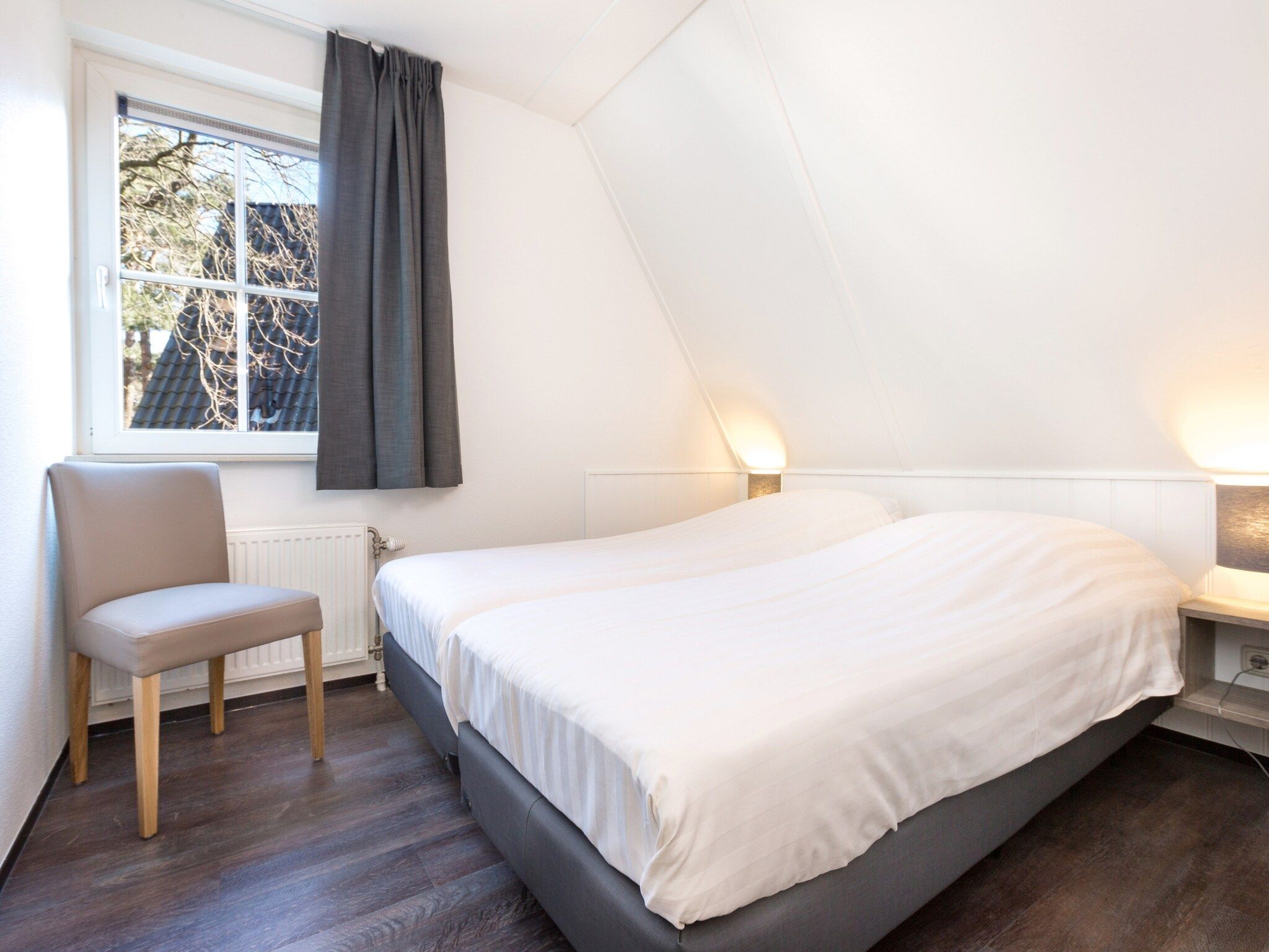 Een slaapkamer van Vakantiepark de Katjeskelder 12 in Oosterhout
