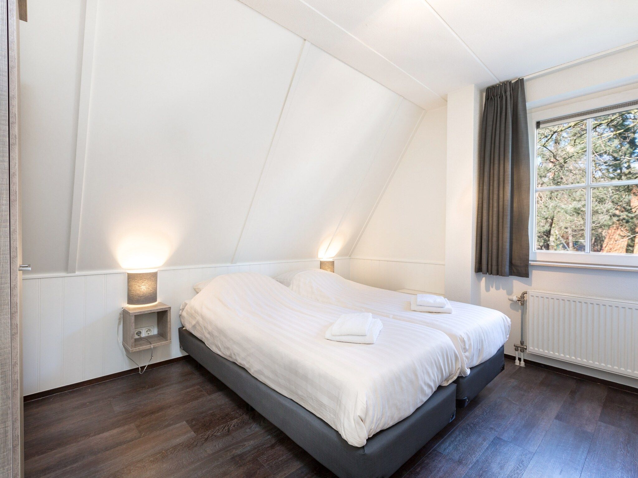 Een slaapkamer van Vakantiepark de Katjeskelder 12 in Oosterhout
