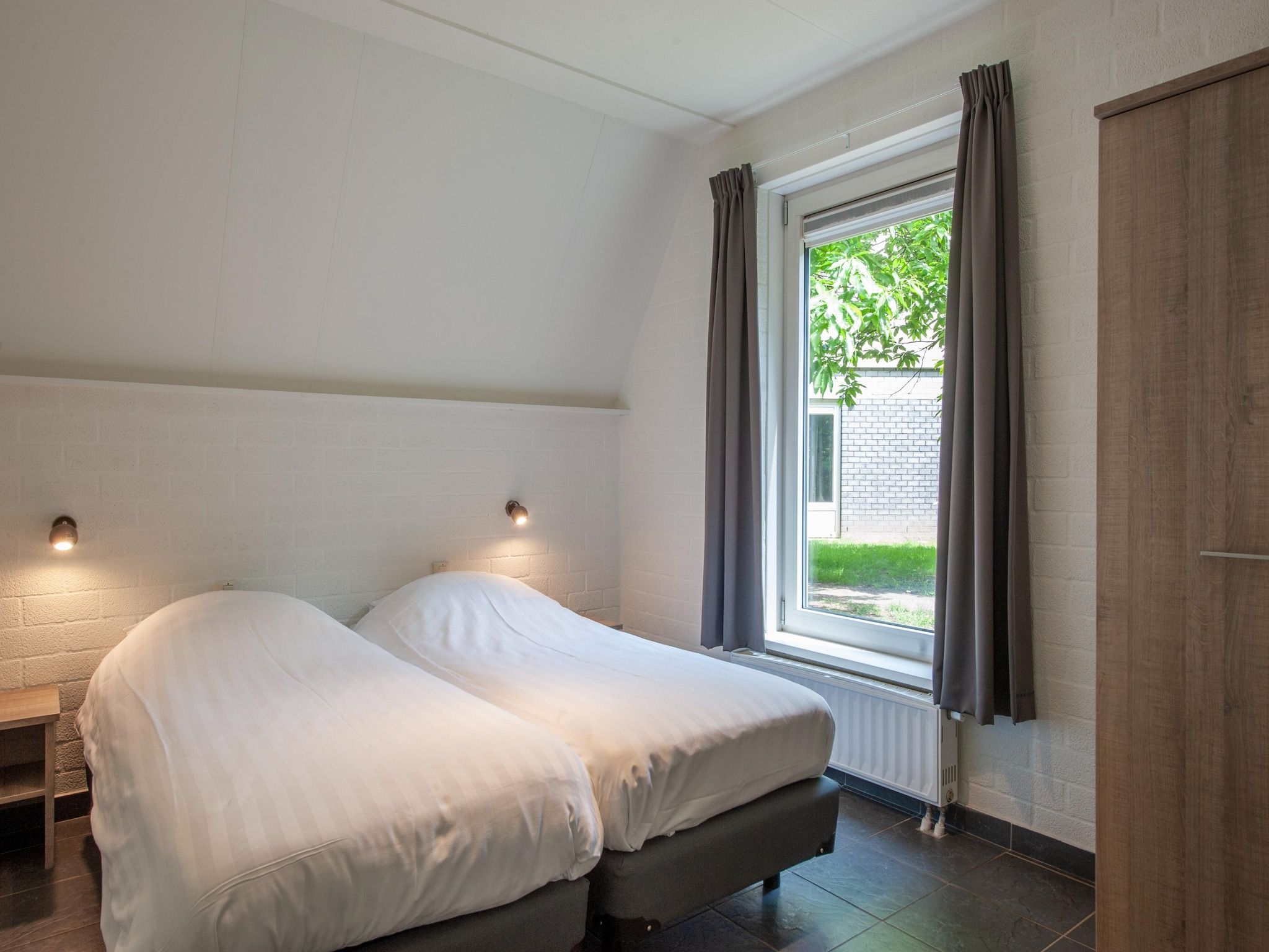 Een slaapkamer van Vakantiepark de Katjeskelder 13 in Oosterhout