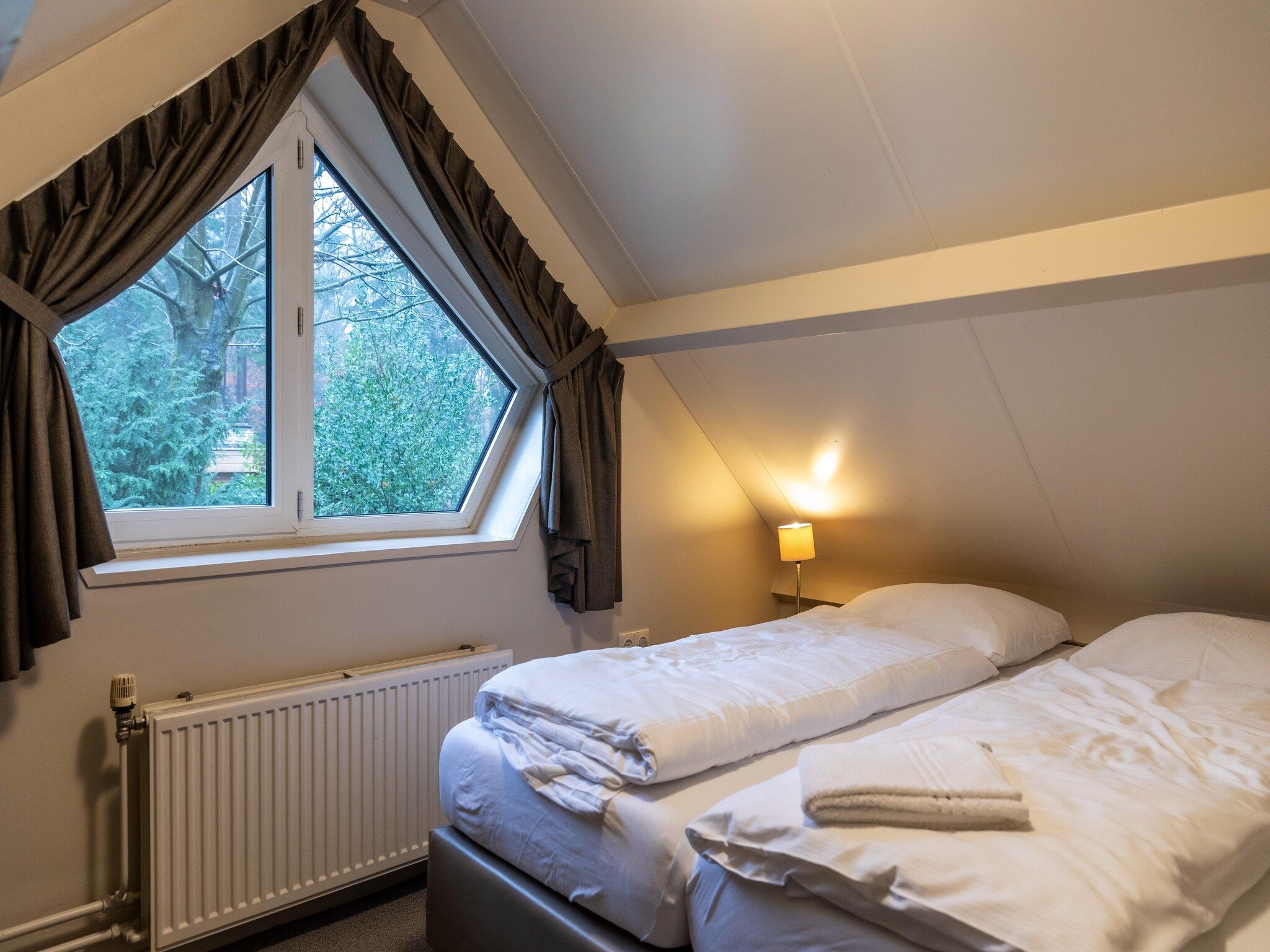 Een slaapkamer van Vakantie bij Meeussen - Schuttersoord 2 in Mook