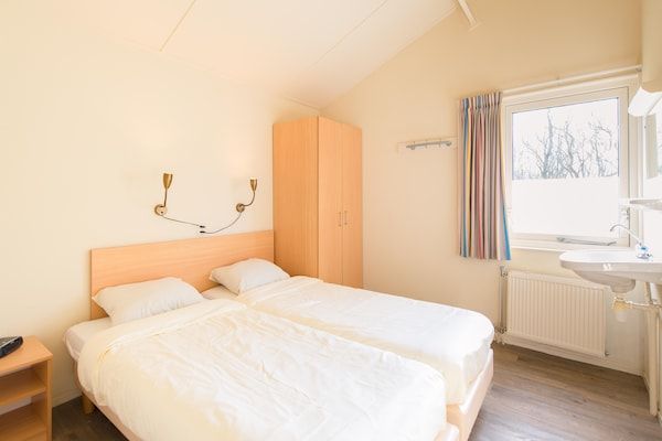 Slaapkamer - Gezellige bungalow op 1,5 km van het strand in Hollum (4)