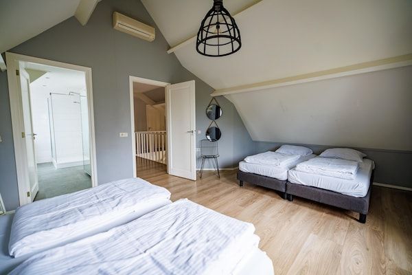 Slaapkamer - Ruime villa aan het meer in Maurik (4)
