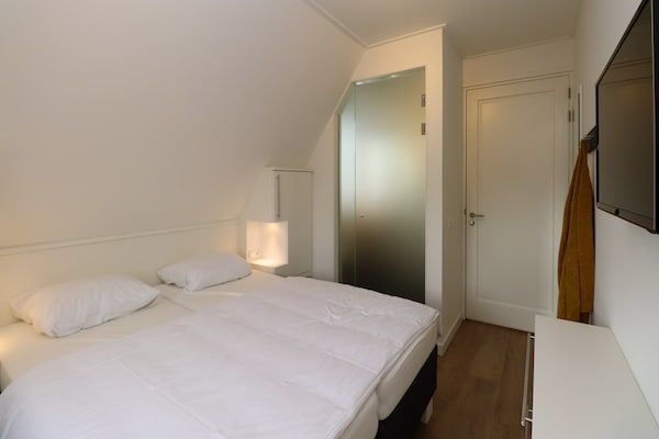 Slaapkamer - Villa aan het meer met terras in Delfstrahuizen (4)