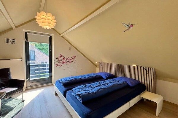 Slaapkamer - Bosretraite met zonneoplader in Ewijk (5)