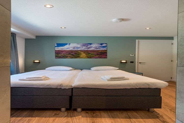 Een slaapkamer van Blauwe Kiekendief in Den Burg